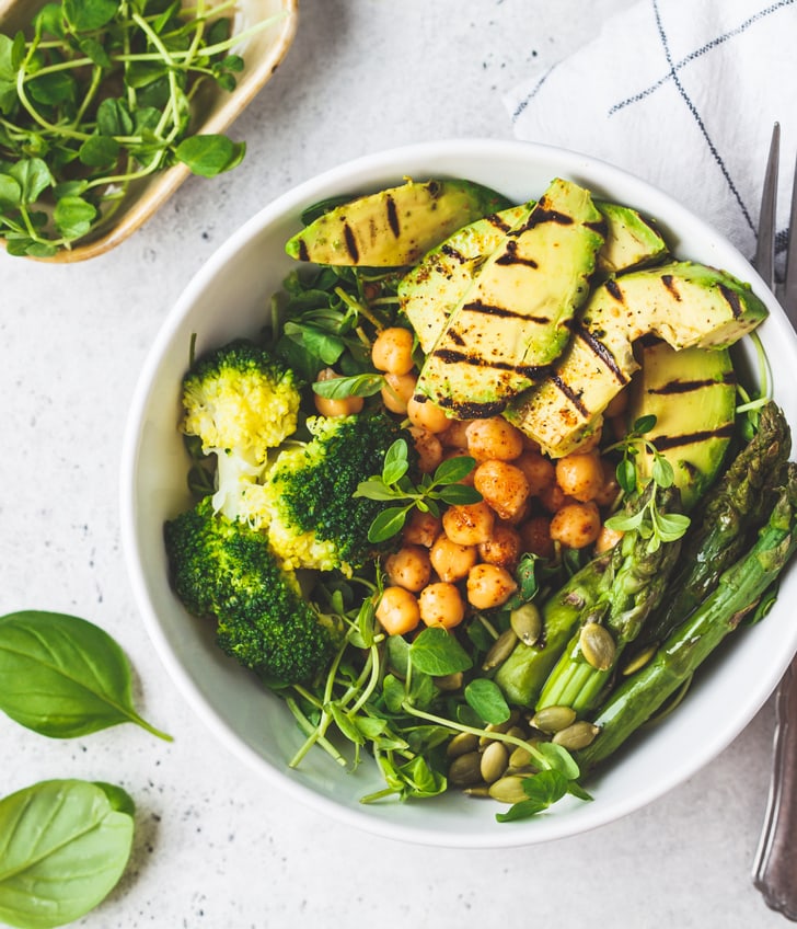 Gesunde Bowl mit Kichererbsen, Spargeln, Broccoli und Avocado.