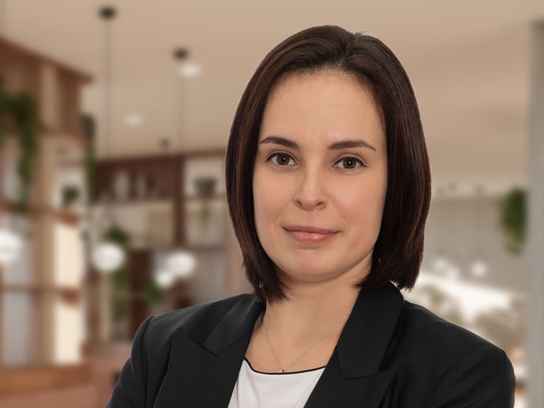 Porträt einer Geschäftsfrau mit verschränkten Armen im Büro.